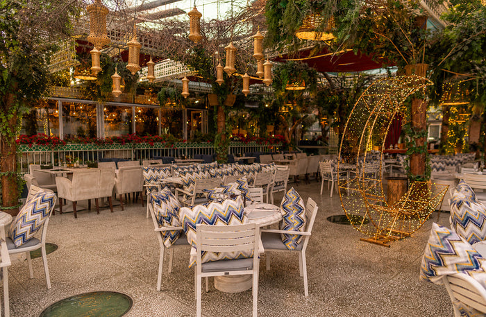 Cello Restaurant Dubai interior with elegant greenhouse-style glass garden