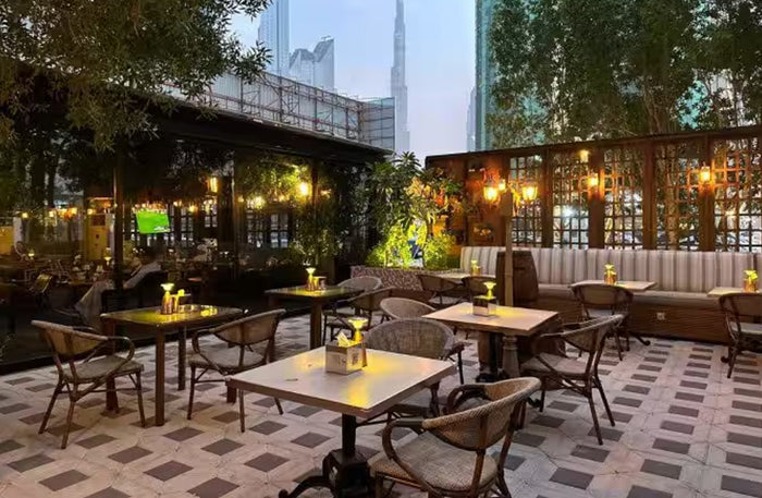 Cello Restaurant Dubai interior with elegant greenhouse-style glass garden