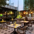 Cello Restaurant Dubai interior with elegant greenhouse-style glass garden